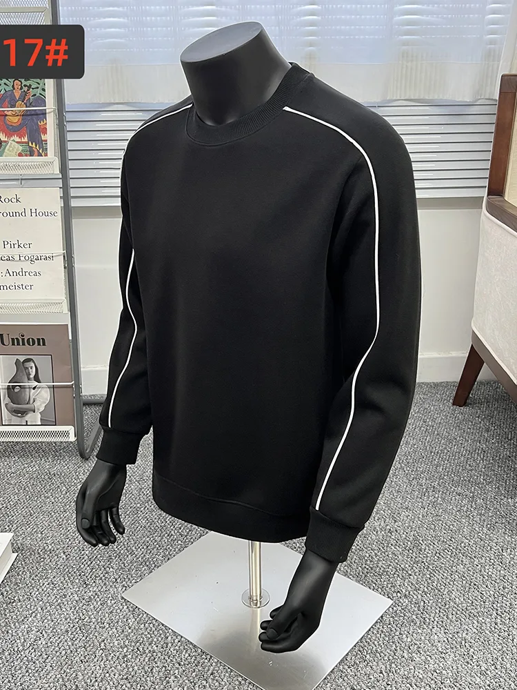 Black crewneck sweatshirt on a mannequin showing contrast piping along the seam